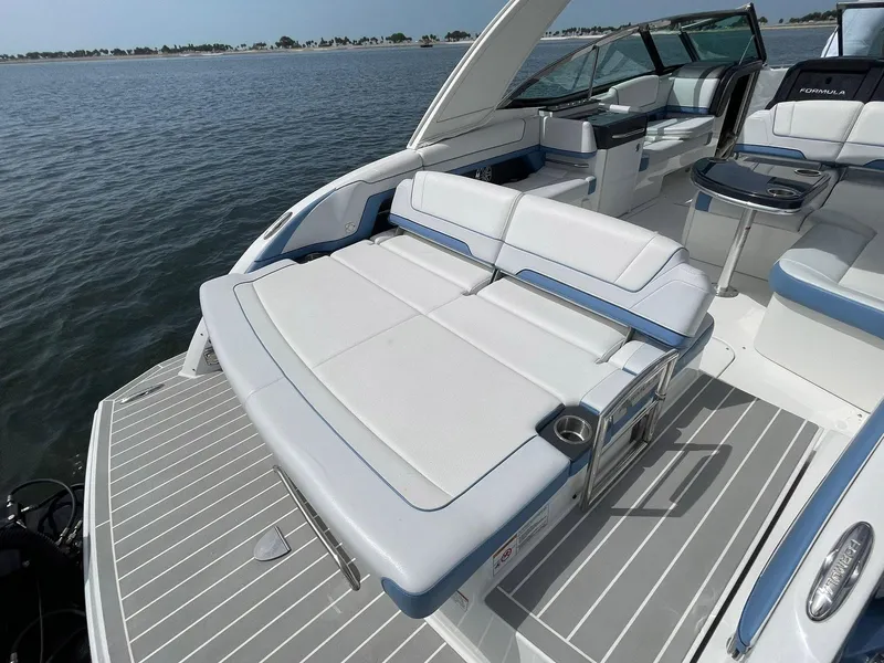 Slide: The Image of 2023 Formula 330 Crossover Bowrider OB with spacious seating on a calm water backdrop. - 39