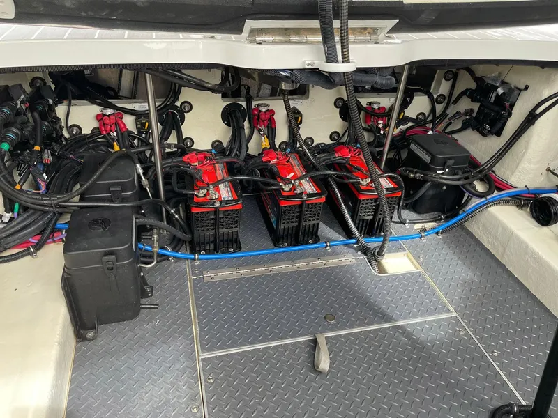 Slide: The Image of 2023 Formula 330 Crossover Bowrider OB engine compartment with batteries and wiring. - 41