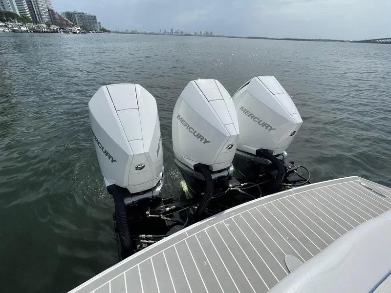 Slide: The Image of 2023 Formula 330 Crossover Bowrider OB with triple Mercury outboard engines on water. - 45