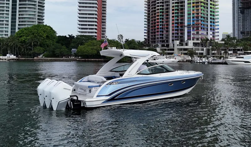 Slide: The Image of 2023 Formula 330 Crossover Bowrider OB on water near cityscape. - 5
