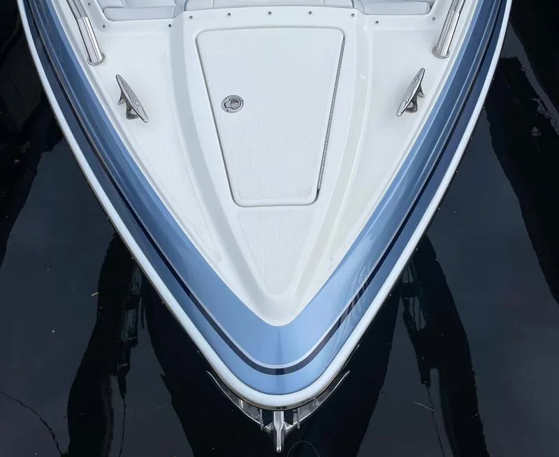 Slide: The Image of 2023 Formula 330 Crossover Bowrider OB, sleek bow design on calm water. - 6