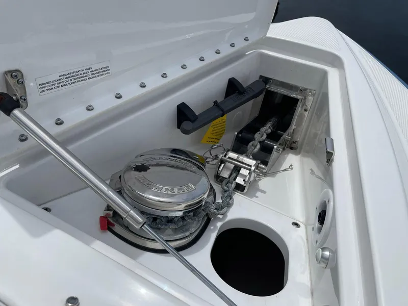 Slide: The Image of 2023 Formula 330 Crossover Bowrider OB anchor compartment with winch and chain. - 7