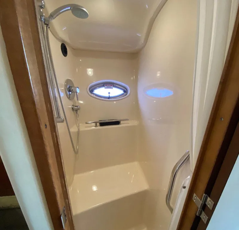 Slide: The Image of Shower area inside 2008 Sea Ray 38 Sundancer yacht, featuring sleek design and porthole window. - 10