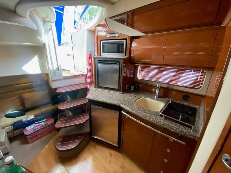 Slide: The Image of Interior of 2008 Sea Ray 38 Sundancer yacht with modern kitchen amenities. - 15