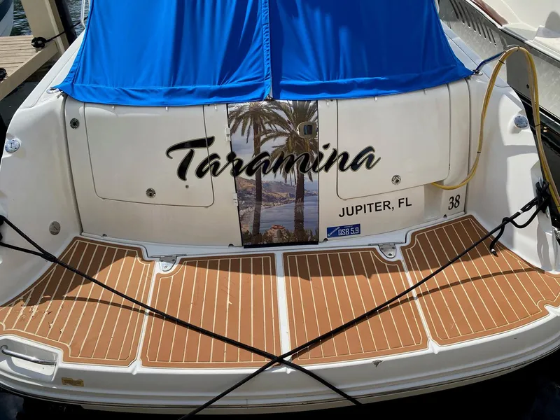 Slide: The Image of 2008 Sea Ray 38 Sundancer boat with blue cover, named "Taormina," docked in Jupiter, FL. - 5