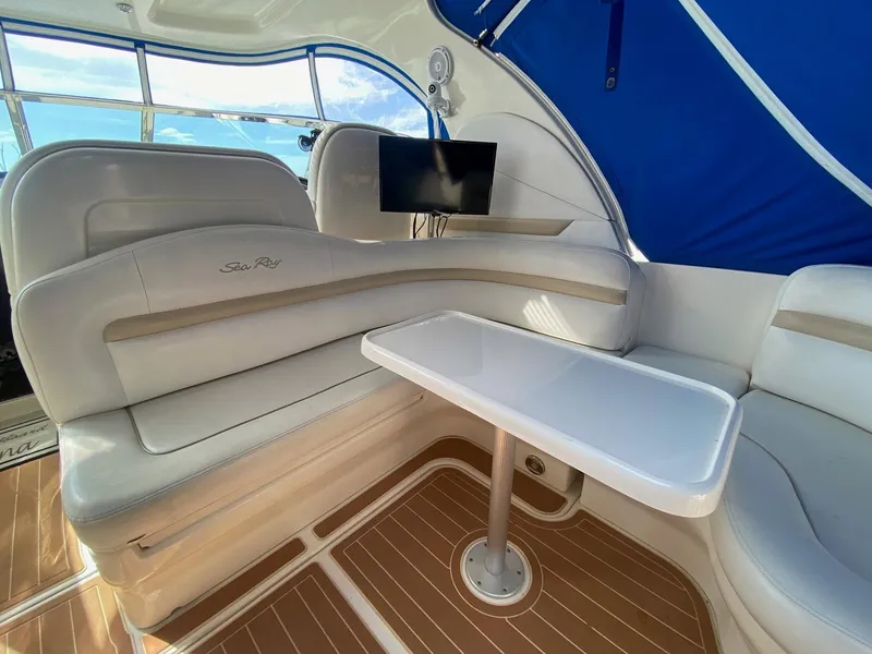 Slide: The Image of 2008 Sea Ray 38 Sundancer interior with seating, table, and mounted TV. - 6