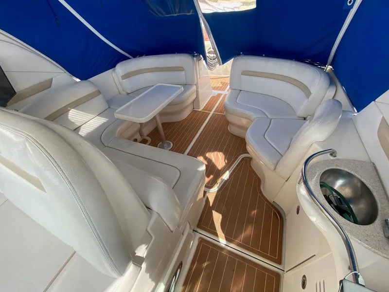 Slide: The Image of Luxurious interior of 2008 Sea Ray 38 Sundancer with white seating and wooden flooring. - 7