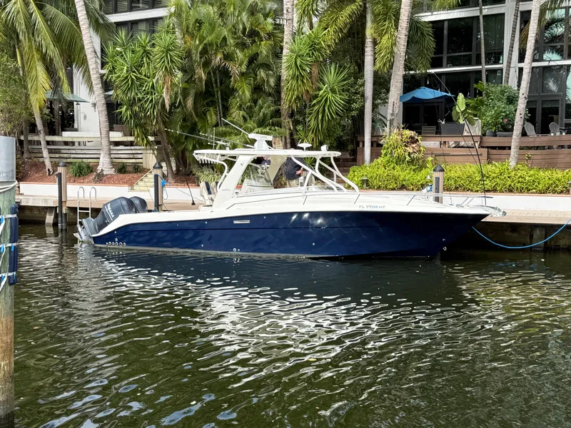 Slide: The Image of 2008 Hydra-Sports Vector 3500 VX boat docked by lush greenery. - 3