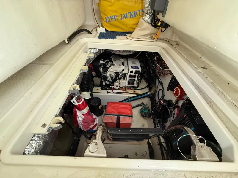 Slide: The Image of Engine compartment of a 2008 Hydra-Sports Vector 3500 VX boat, showing equipment and storage. - 33