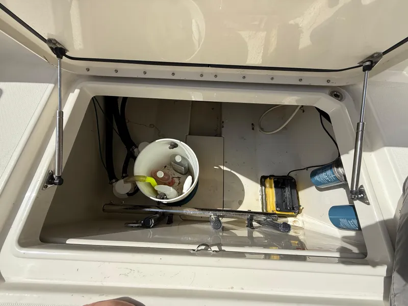 Slide: The Image of Storage compartment of 2008 Hydra-Sports Vector 3500 VX boat with various items inside. - 49