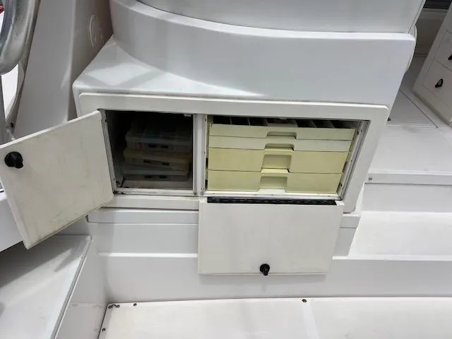 Slide: The Image of Storage compartments on a 1997 Blackfin 30.7 EXPRESS boat, featuring organized tackle boxes. - 14