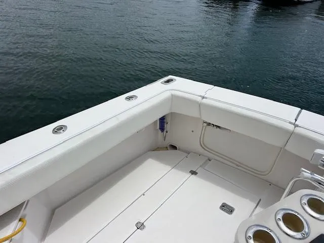 Slide: The Image of 1997 Blackfin 30.7 EXPRESS boat deck with rod holders, docked on calm water. - 15