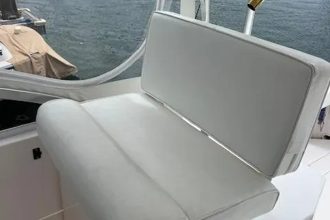 Slide: The Image of White seating on 1997 Blackfin 30.7 EXPRESS boat, near water. - 17