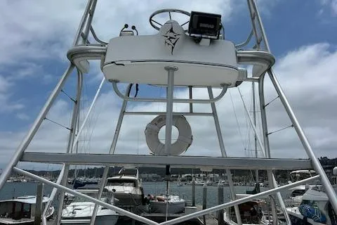 Slide: The Image of 1997 Blackfin 30.7 EXPRESS boat tower with life preserver, docked at marina under cloudy sky. - 26