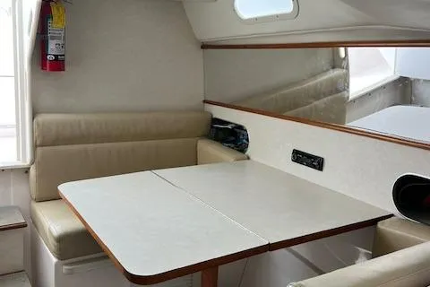Slide: The Image of Interior of 1997 Blackfin 30.7 EXPRESS boat with beige seating and table. - 28