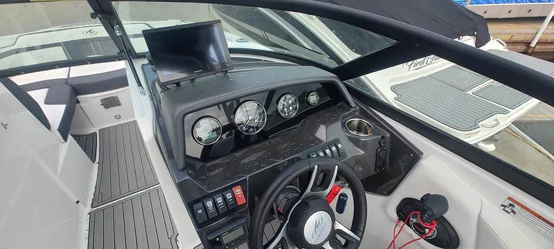 Slide: The Image of Cockpit view of 2021 Monterey M4 boat with steering wheel and control panel. - 10
