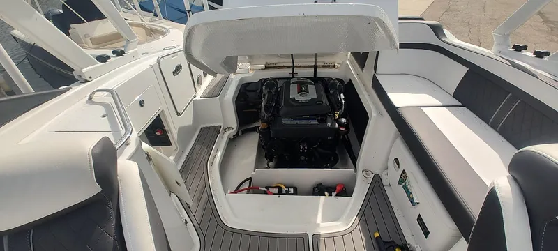 Slide: The Image of 2021 Monterey M4 boat engine compartment with open hatch, showcasing interior layout. - 12