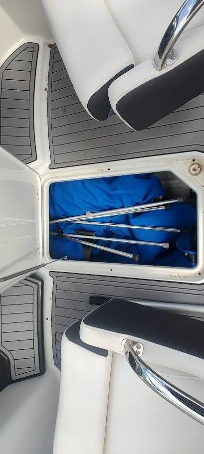 Slide: The Image of 2021 Monterey M4 boat interior with storage compartment and blue cover. - 15