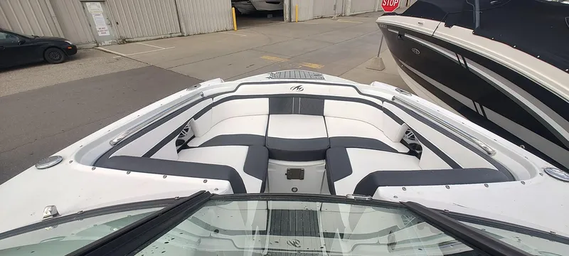 Slide: The Image of 2021 Monterey M4 boat with white and gray seating, docked near other boats. - 8