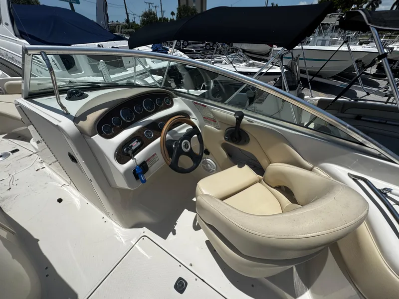 Slide: The Image of 2001 Sea Ray 240 Sundeck boat interior with steering wheel and dashboard controls. - 4
