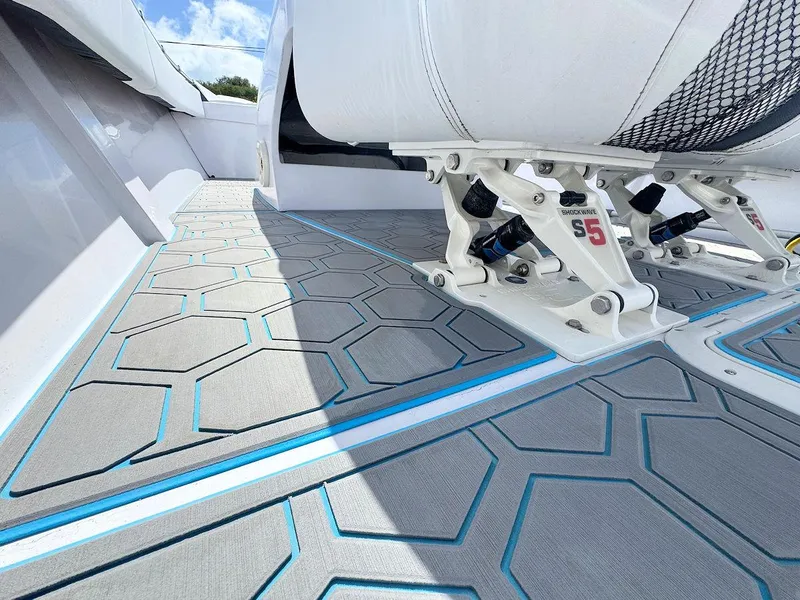 Slide: The Image of 2022 Phantom 32 CC boat interior with hexagonal patterned flooring and cushioned seating. - 11