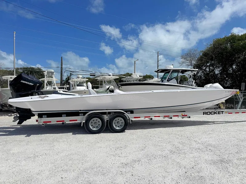 Slide: The Image of 2022 Phantom 32 CC boat on trailer under blue sky. - 4