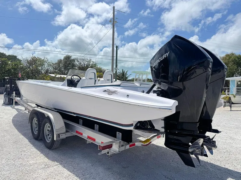 Slide: The Image of 2022 Phantom 32 CC boat on trailer with dual Mercury engines, parked outdoors. - 6