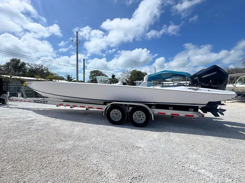 Slide: The Image of 2022 Phantom 32 CC boat on trailer under blue sky. - 7