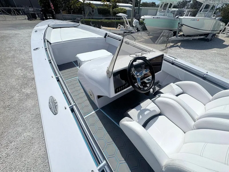 Slide: The Image of 2022 Phantom 32 CC boat interior with white seating and steering console. - 8