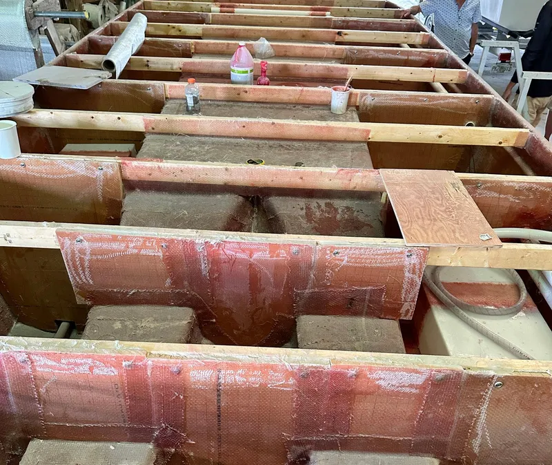 Slide: The Image of 2023 Beachcat 26 Tiki COI under construction, showcasing interior framework and materials. - 20