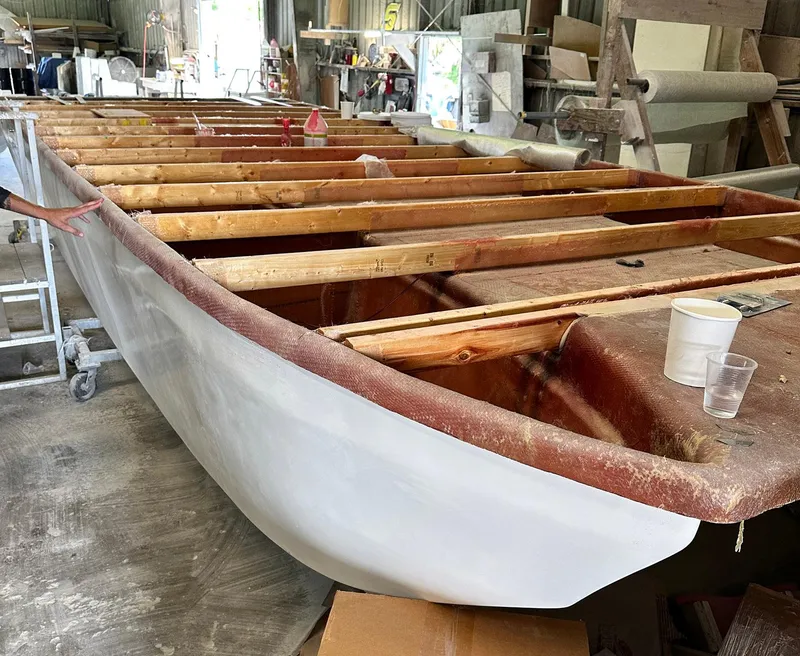Slide: The Image of 2023 Beachcat 26 Tiki COI boat under construction in a workshop. - 21