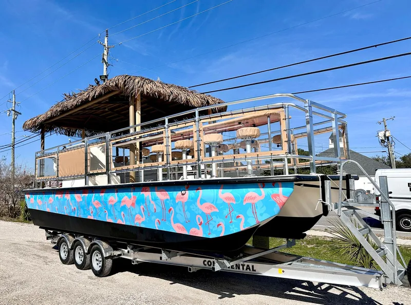 Slide: The Image of 2023 Beachcat 26 Tiki COI boat with flamingo design on trailer. - 33
