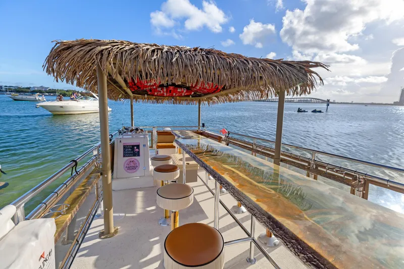 Slide: The Image of Tiki-themed Beachcat 26 Tiki COI boat with bar stools and ocean view, 2023 model. - 8