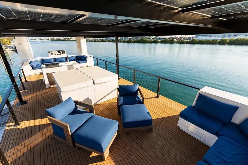 Slide: The Image of Luxurious deck of 2025 Custom Arkup 50 with blue seating and waterfront view. - 12
