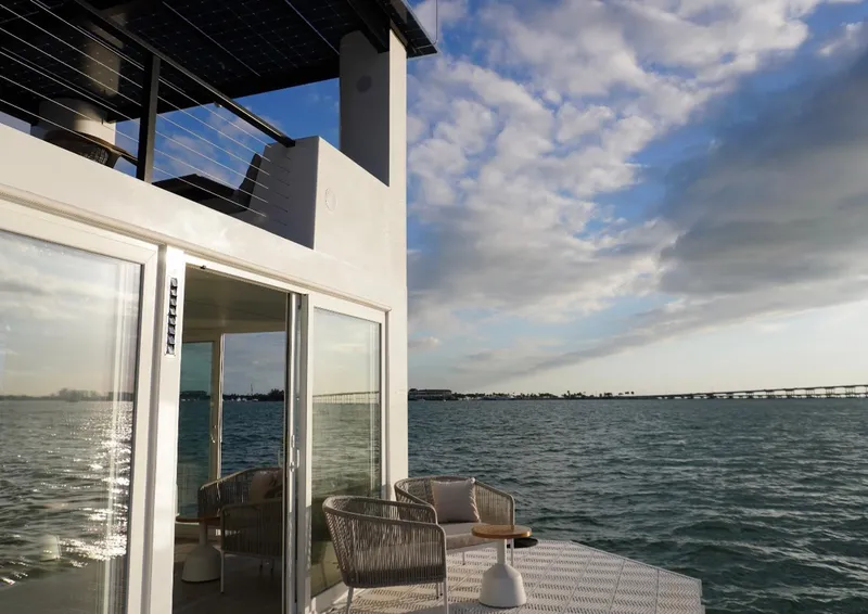 Slide: The Image of Floating home Arkup 50 on water, modern design, outdoor seating, ocean view, cloudy sky. - 16