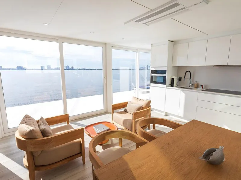 Slide: The Image of Modern Arkup 50 interior with ocean view, featuring sleek kitchen and cozy seating area. - 17