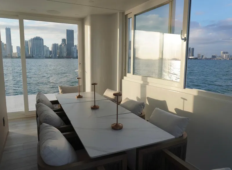 Slide: The Image of Modern dining area on Arkup 50 houseboat with city skyline view, 2025 model. - 18