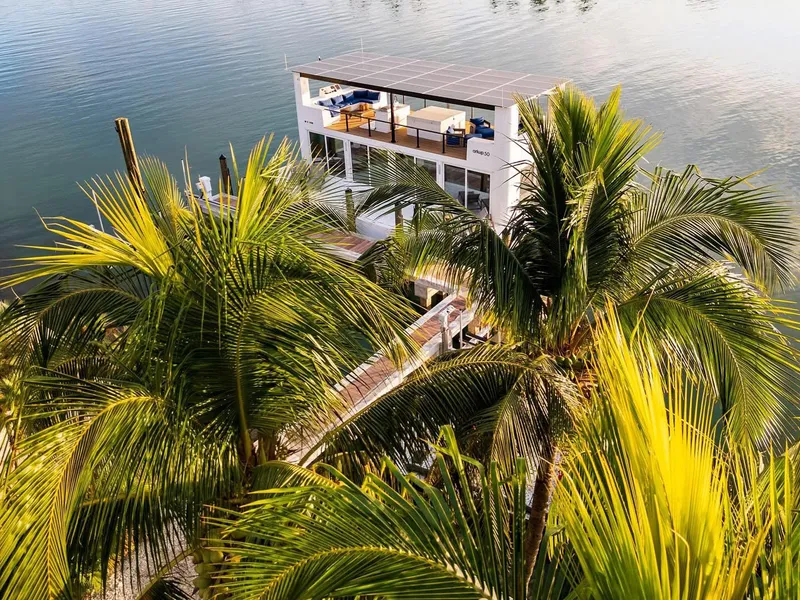 Slide: The Image of Floating luxury home Arkup 50 amidst lush palm trees on serene water. - 22