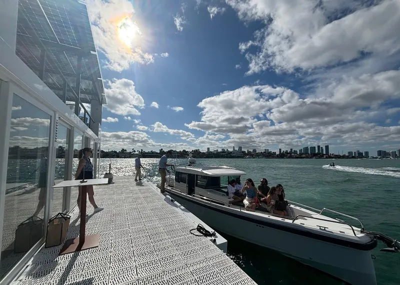 Slide: The Image of Floating houseboat Arkup 50 with solar panels, docked by a scenic waterfront, 2025. - 23
