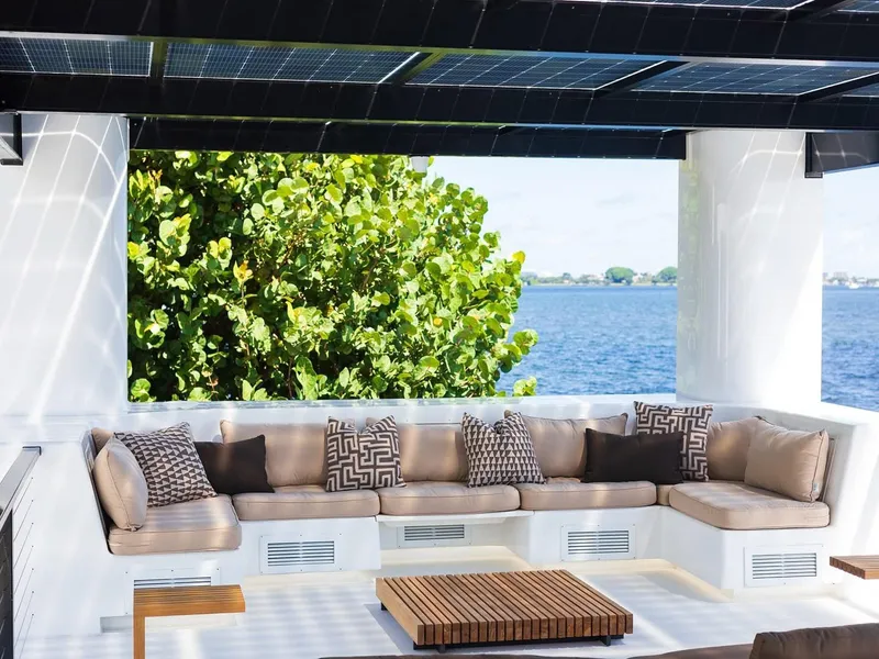 Slide: The Image of Luxurious outdoor seating on Arkup 50 houseboat, featuring modern cushions and waterfront view. - 7