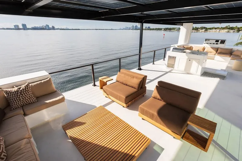Slide: The Image of Luxurious Arkup 50 yacht deck with modern seating, overlooking serene waterfront views. - 8