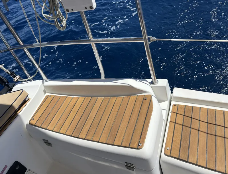 Slide: The Image of Jeanneau Sun Odyssey 39i Performance 2010 yacht deck with wooden seating, ocean view. - 15