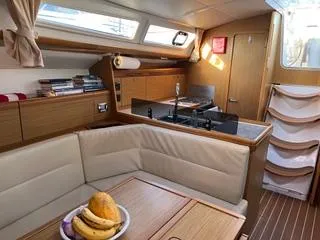 Slide: The Image of Interior of 2010 Jeanneau Sun Odyssey 39i Performance yacht with cozy seating and kitchen area. - 17