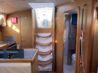 Slide: The Image of Interior of 2010 Jeanneau Sun Odyssey 39i Performance sailboat, featuring kitchen and bathroom. - 23