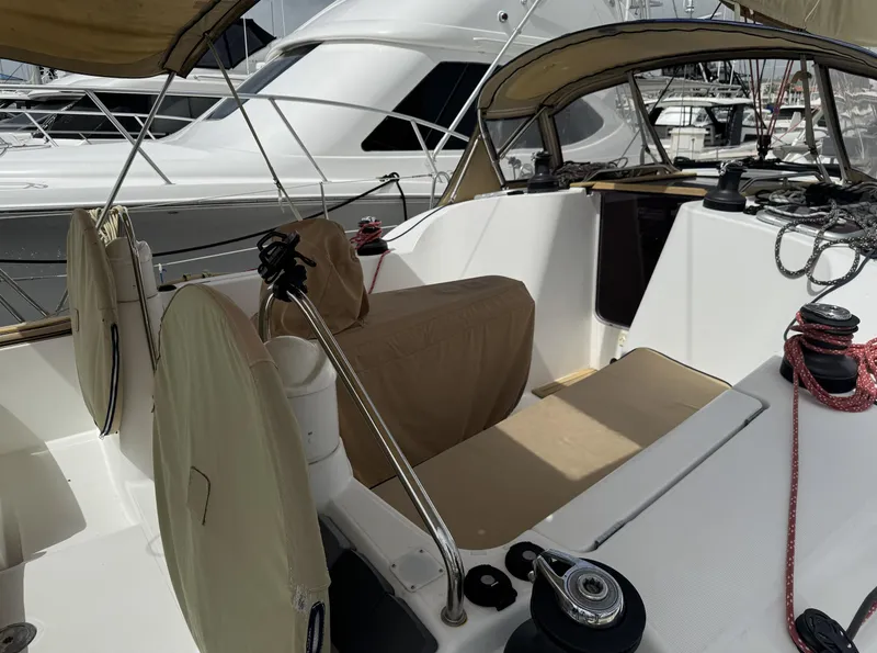 Slide: The Image of Cockpit of 2010 Jeanneau Sun Odyssey 39i Performance sailboat, featuring covered seating and winches. - 5