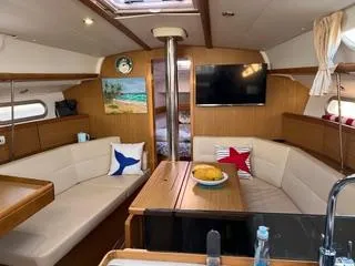 Slide: The Image of Interior of 2010 Jeanneau Sun Odyssey 39i Performance yacht, featuring cozy seating and modern amenities. - 25