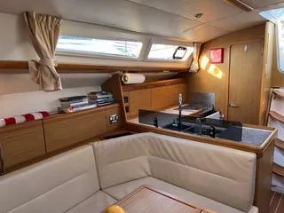 Slide: The Image of Interior of 2010 Jeanneau Sun Odyssey 39i Performance yacht, featuring cozy seating and modern kitchen. - 27