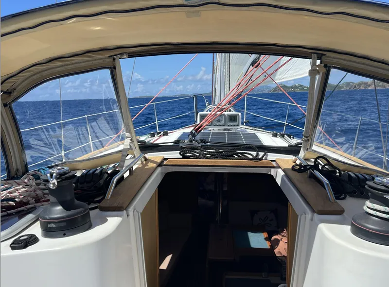 Slide: The Image of 2010 Jeanneau Sun Odyssey 39i Performance sailboat on open sea, cockpit view. - 7