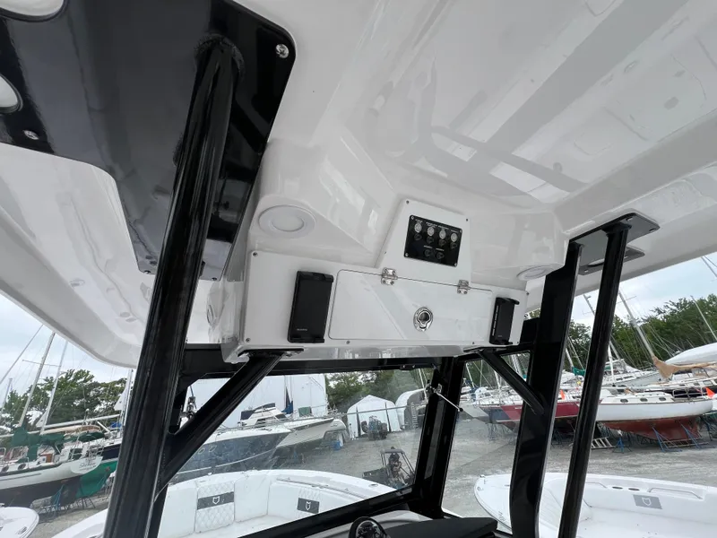 Slide: The Image of 2025 Sea Fox 288 Commander boat interior with overhead console and storage. - 9
