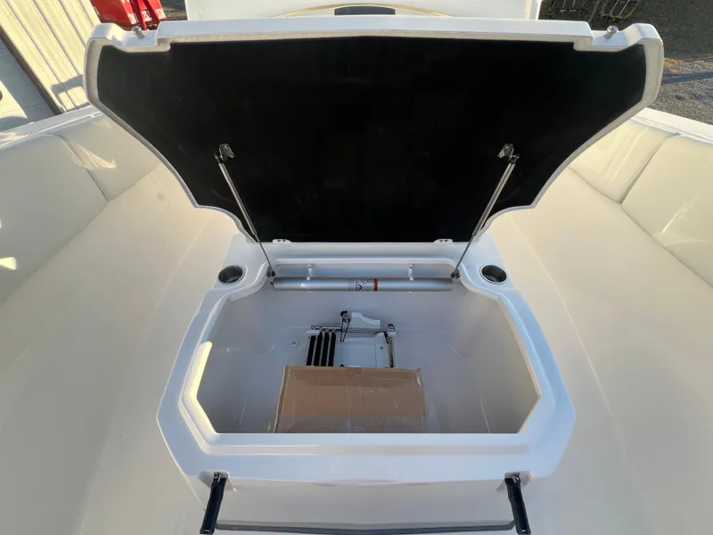 Slide: The Image of 2025 Sea Fox 288 Commander storage compartment with open lid, showcasing spacious interior. - 5